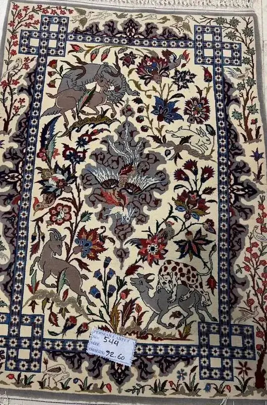 "Antique-style Persian rug from Iran, 90 cm x 60 cm, handcrafted with intricate wool and silk designs, ideal for adding traditional elegance to your space."